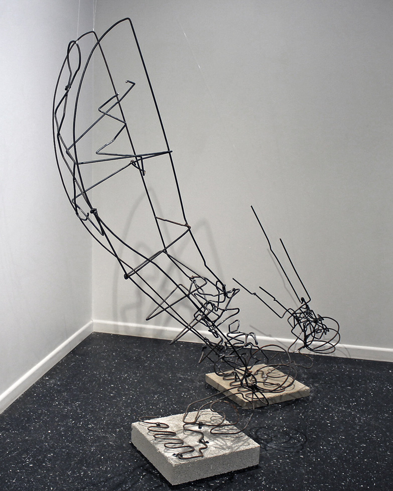 welded sculpture of large wire legs, mounted to concrete blocks