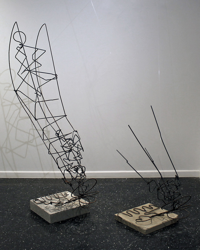 welded sculpture of large wire legs, mounted to concrete blocks