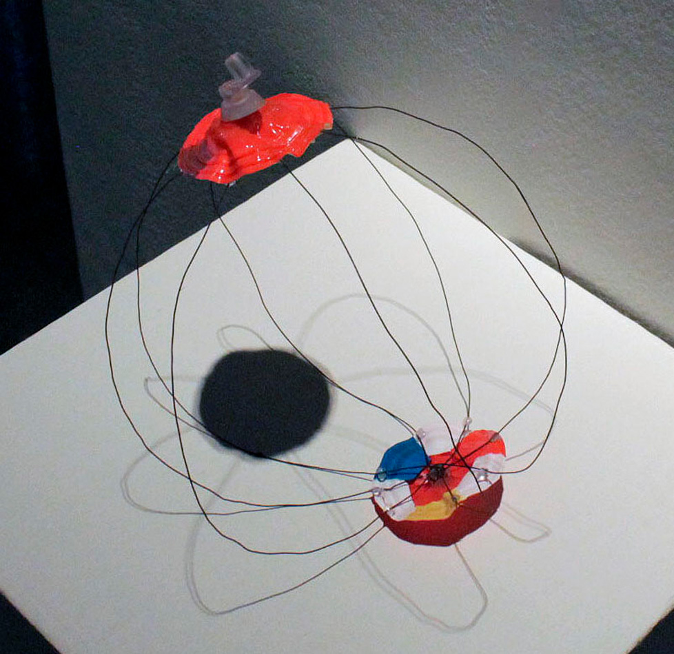 sculpture: wire sphere with ends of beach ball
