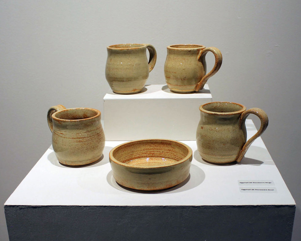 four tan mugs and a bowl