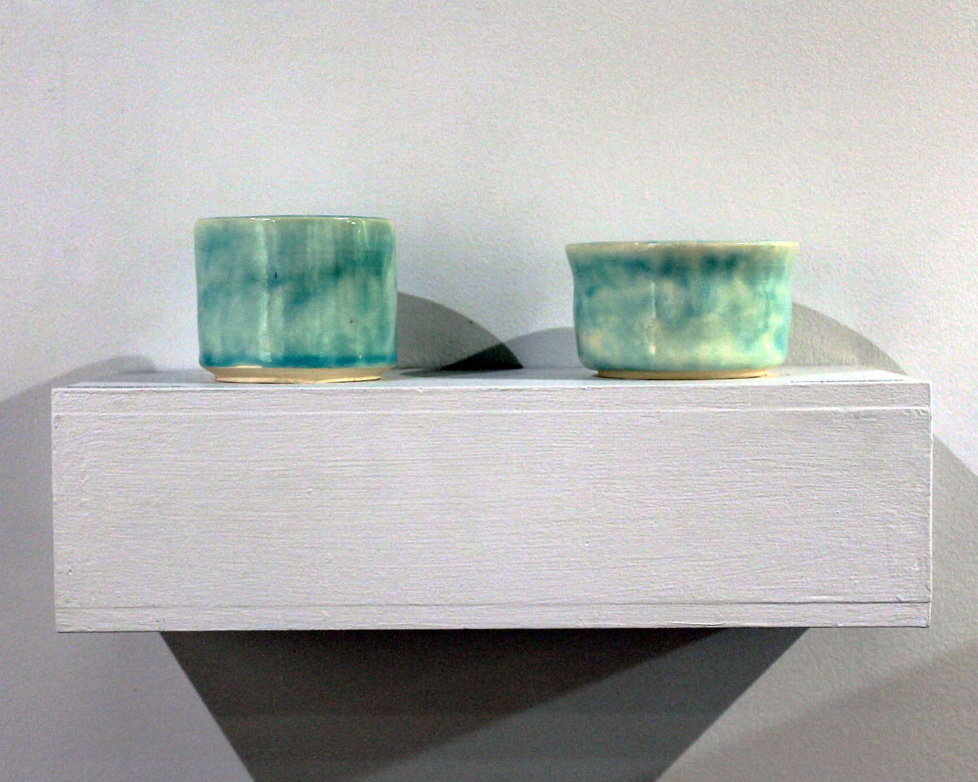 two spearment green ceramic dishes
