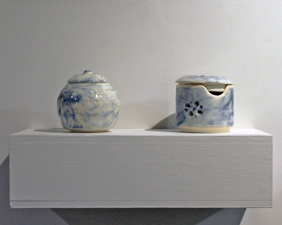two blue and white ceramic jars with lids