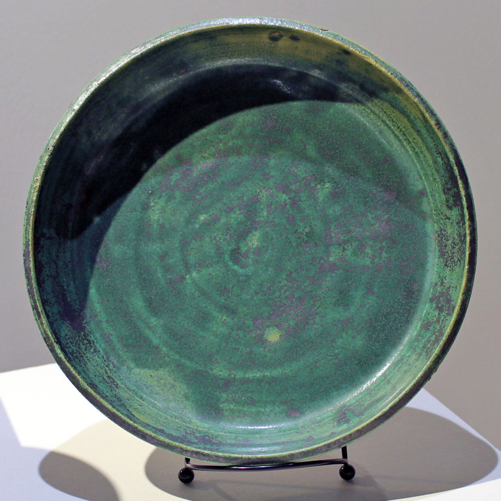green ceramic tray displayed on plate stand