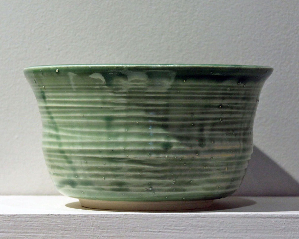 spearming green porcelain bowl with ridged texture, slightly flared lip