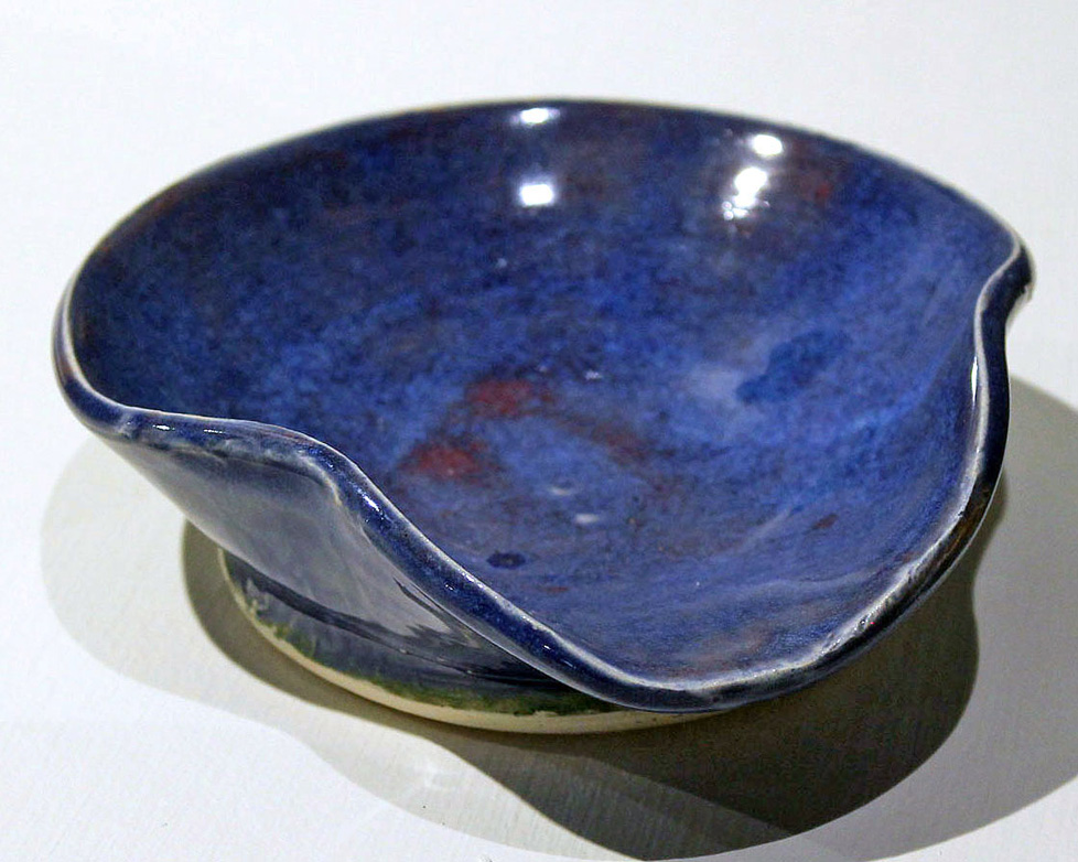 blue ceramic bowl with a depressed lip, like a spoon rest