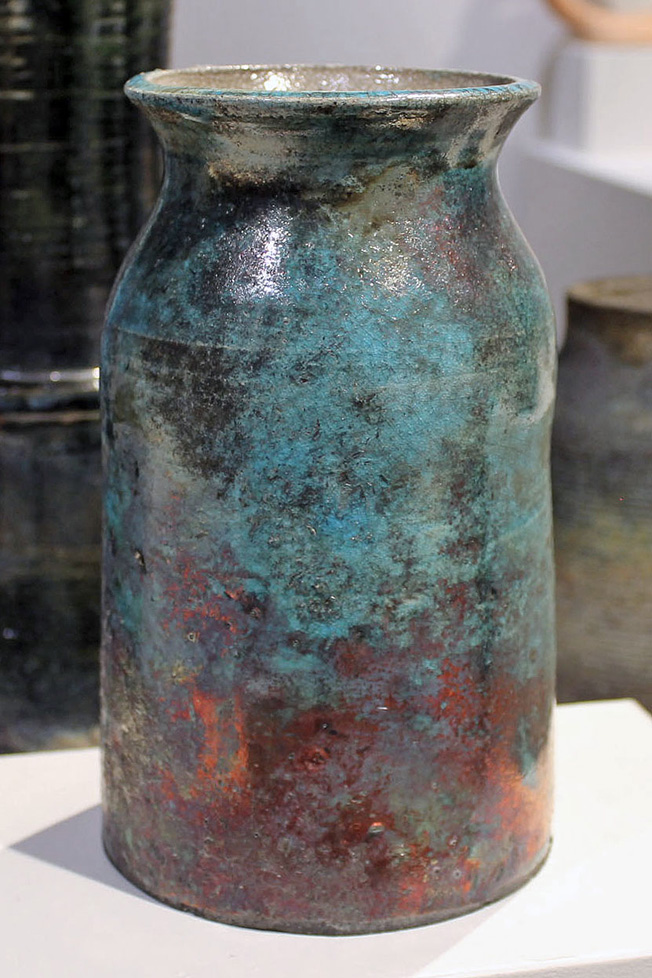 cylindrical vessel with flared lip, patina-like colors