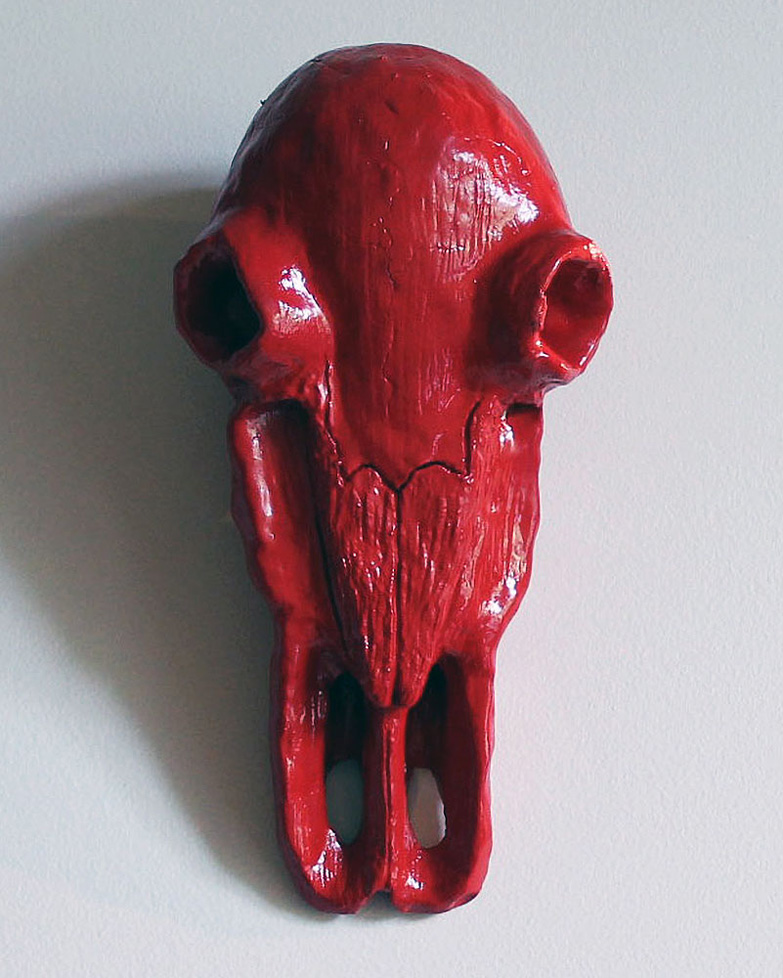 sculpted animal skull, painted red
