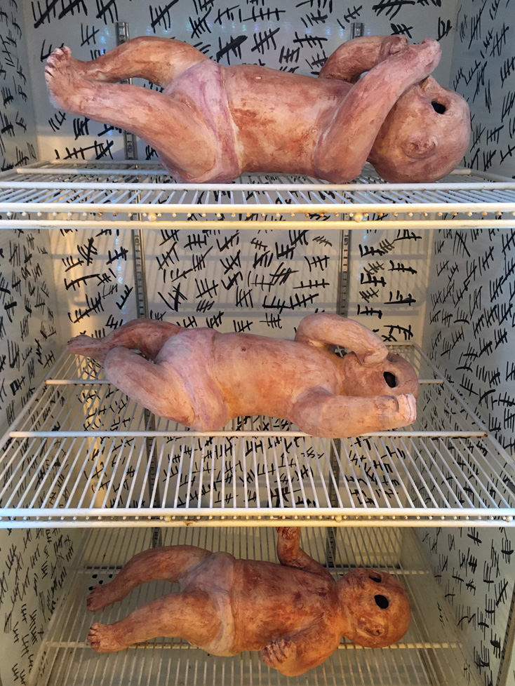 detail of babies of the babies inside the cooler, tic marks on the walls