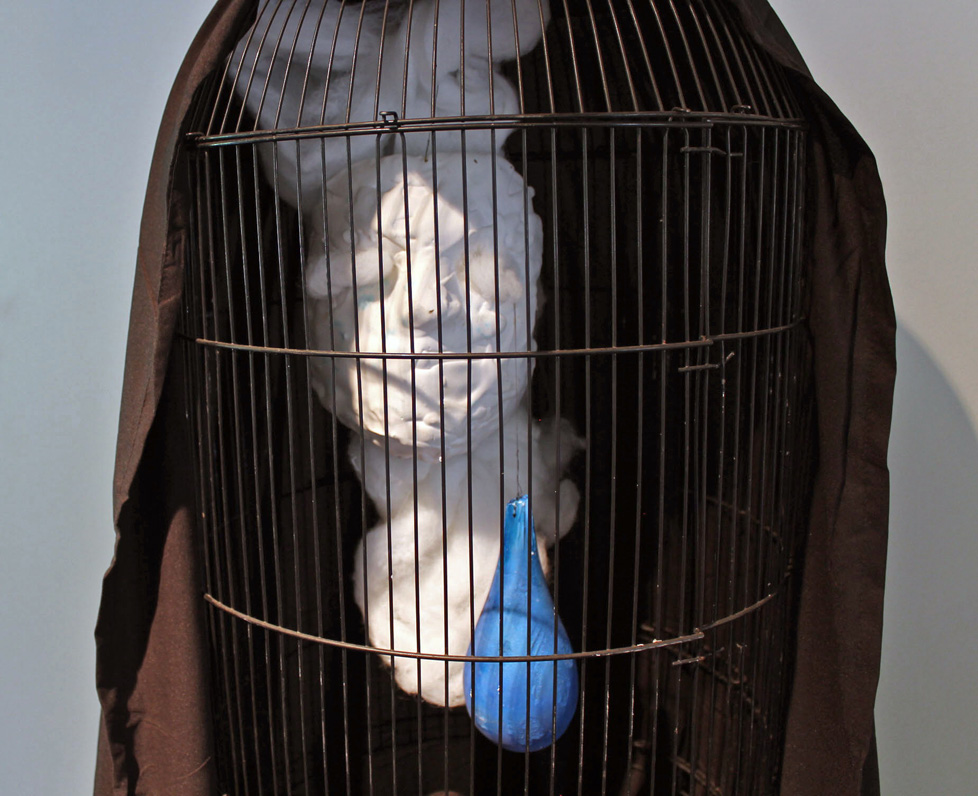 detail of cage and head with cast blue balloon