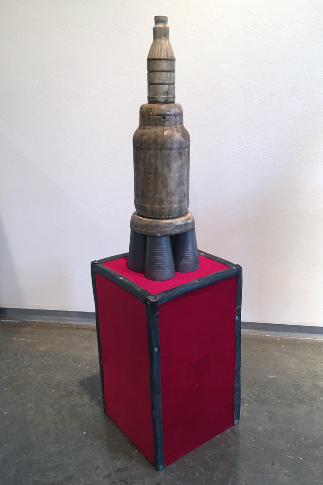 tower of cast objects on red box