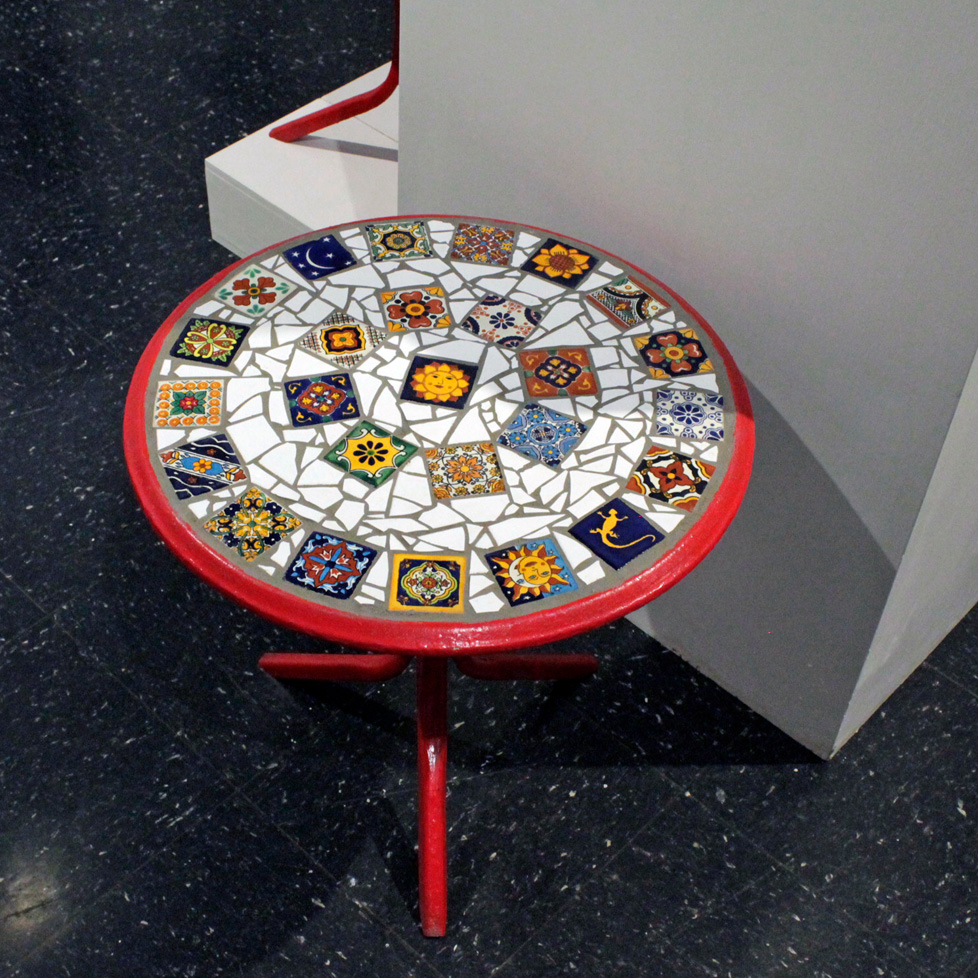 small round table painted red with tiled top