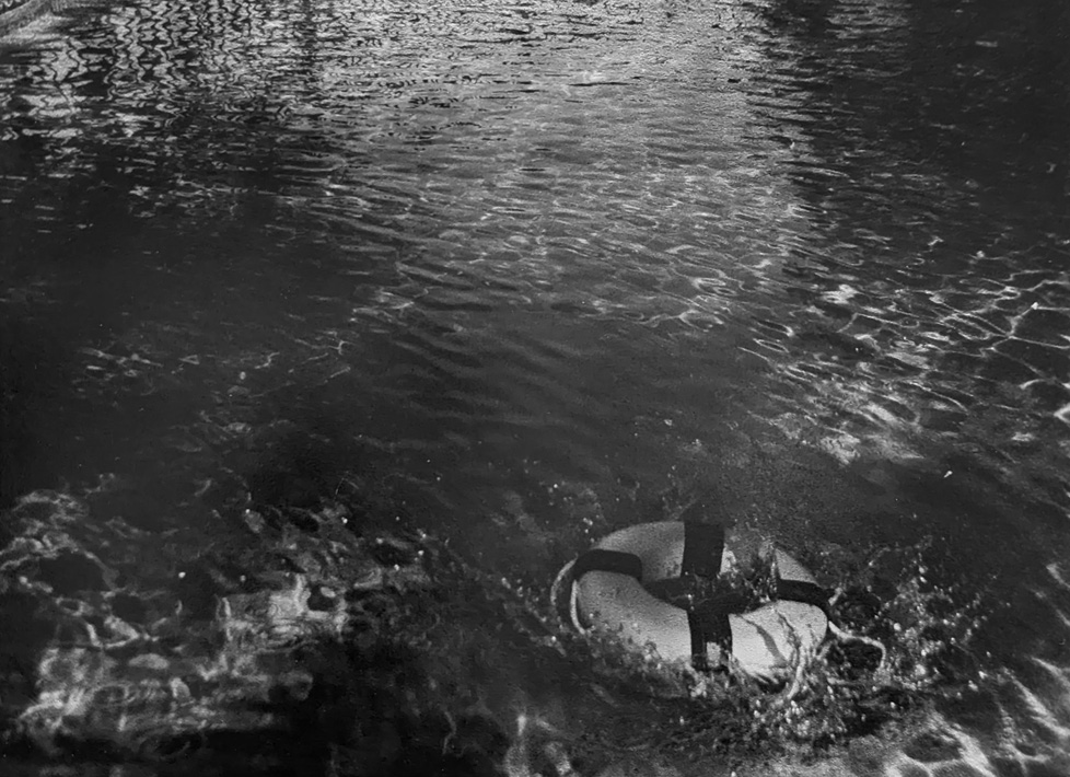 b/w photo of life preserver in water