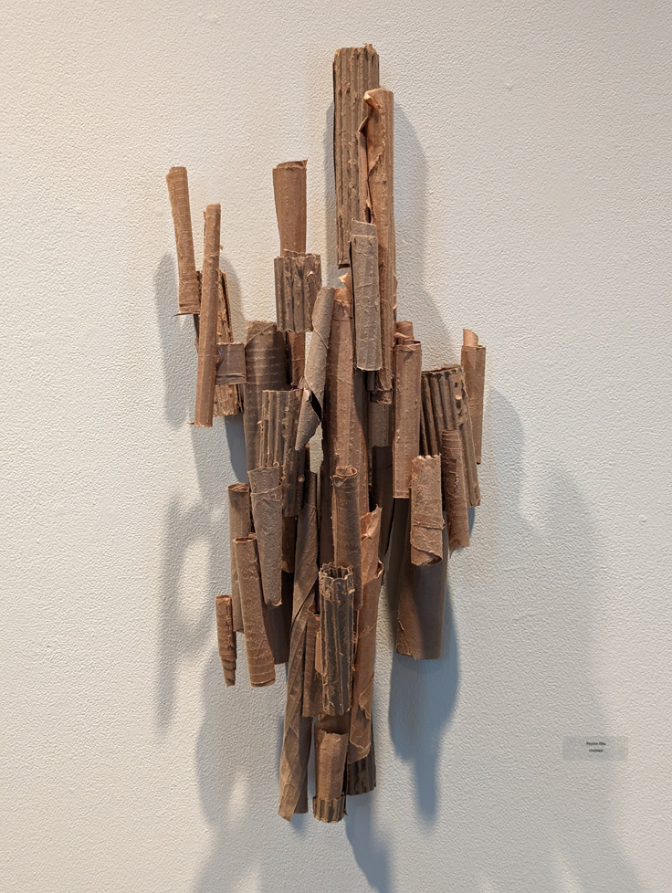 wal-hanging sculpture of cardboard tubes