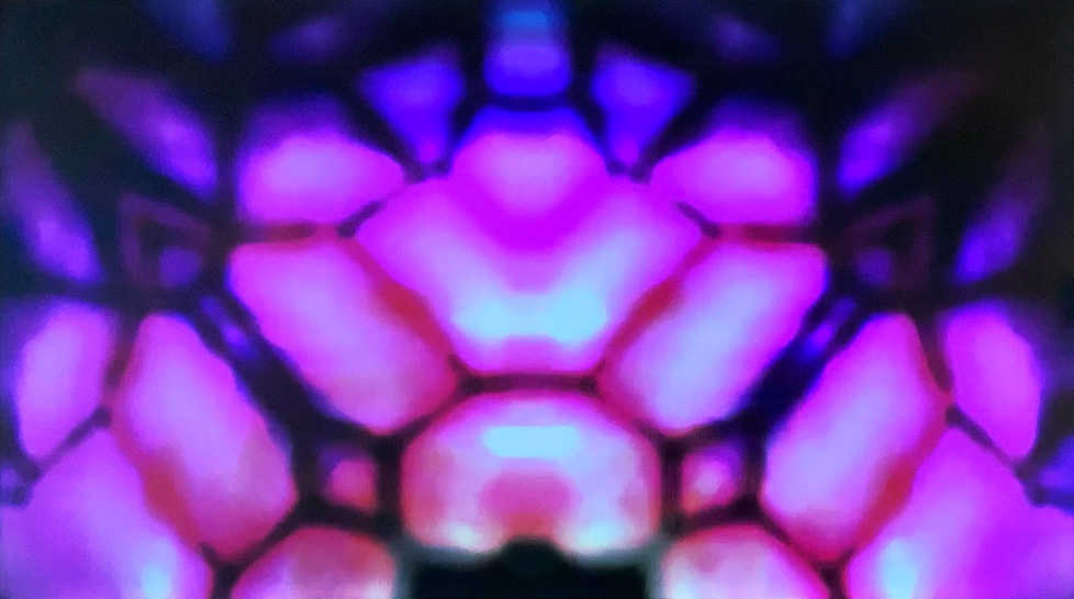 video still: kaleidoscopic abstraction of pinks and purples