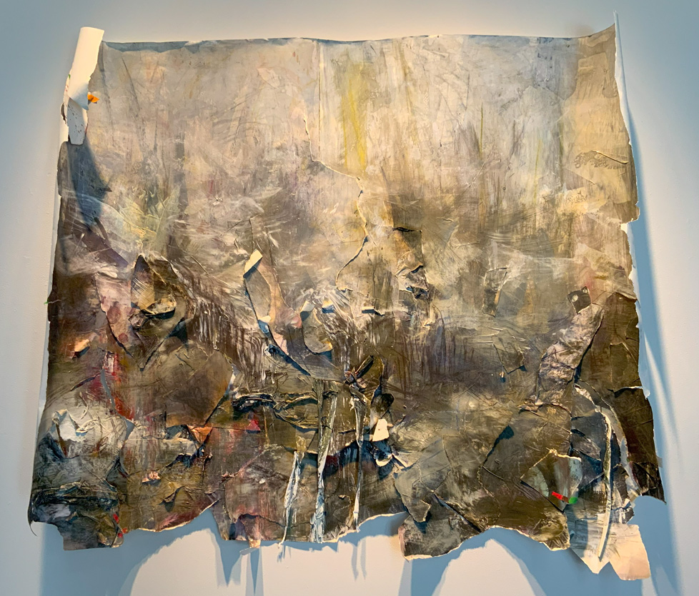 large painting on torn paper with curled edges, earth tones