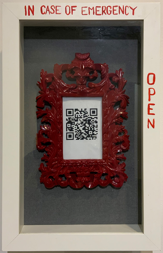 shadow box containing framed QR code