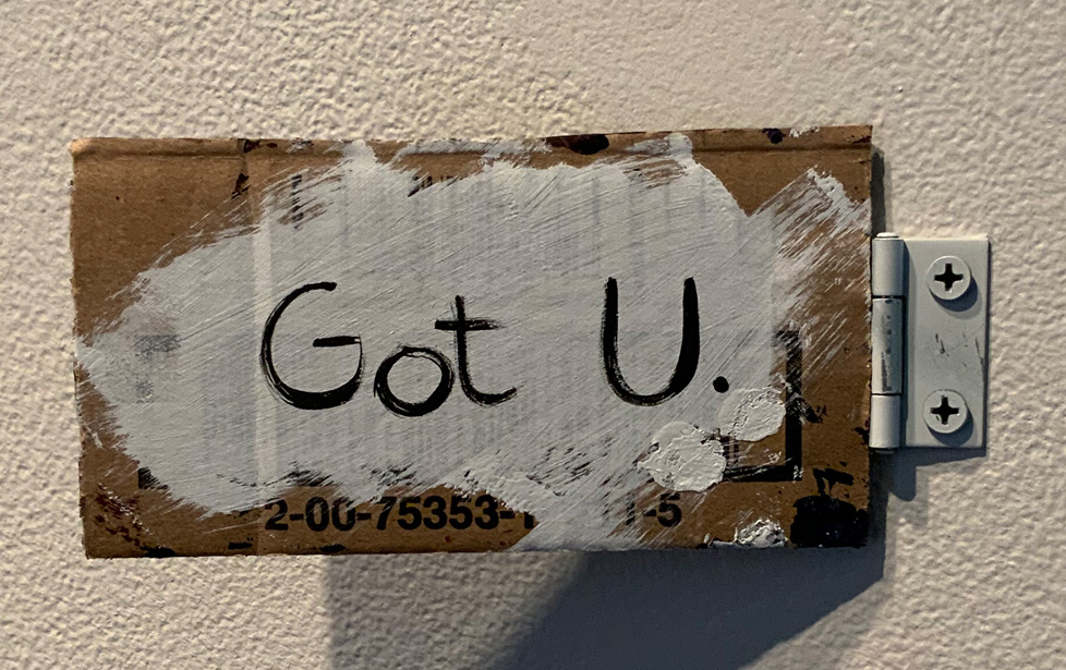 "Got U." written on cardboard