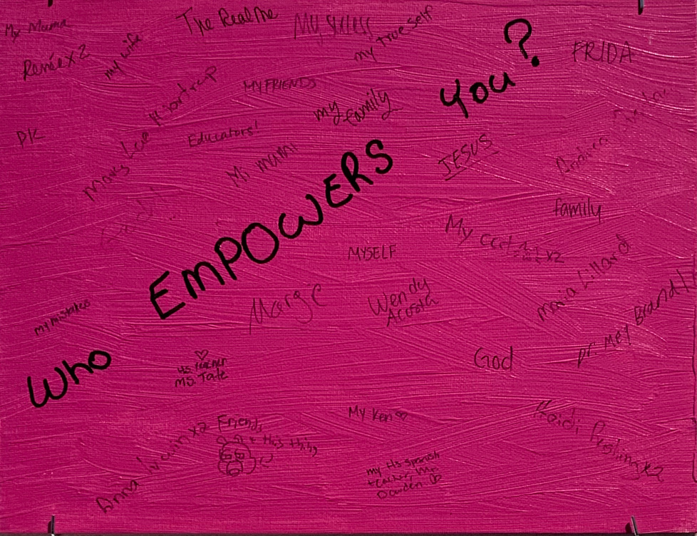 pink canvas board inviting people to write the names of who empowers them