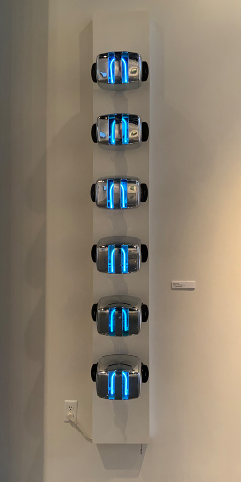 row of toasters lit by neon tubes from within