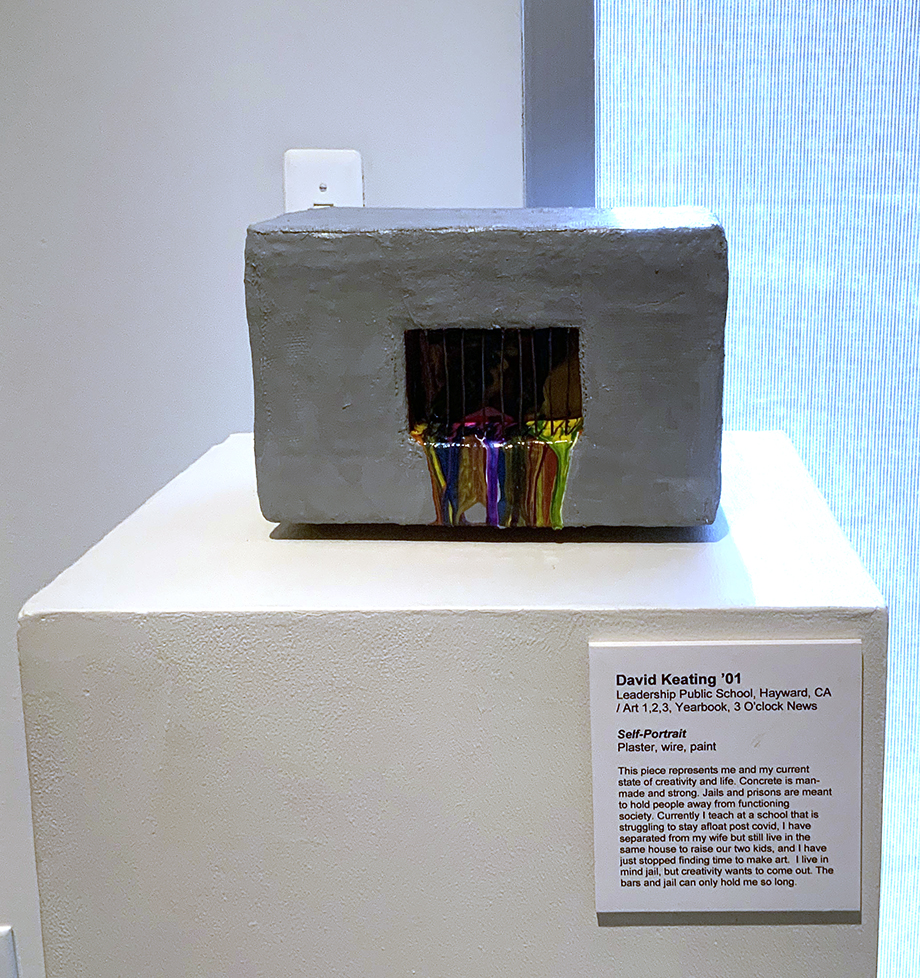 sculpture: box with jail-like bars and melted colors pouring out