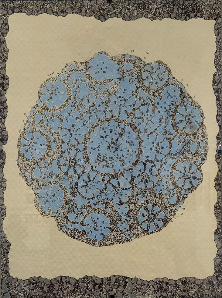 round lace-like pattern in blue and black on cream ground