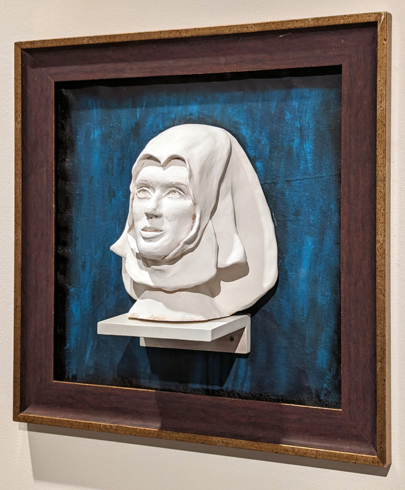 angled view of ceramic bust of woman in frame