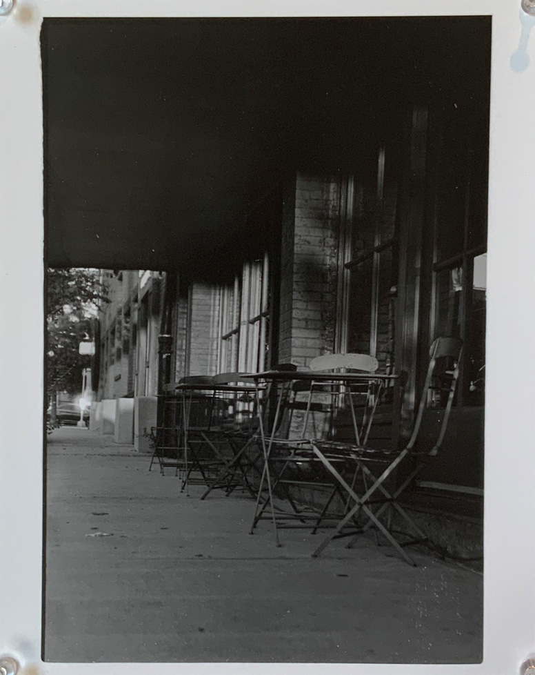 photo of sidewalk with chairs