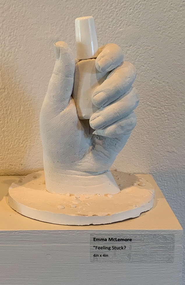 plaster cast of hand holding fingernail polish