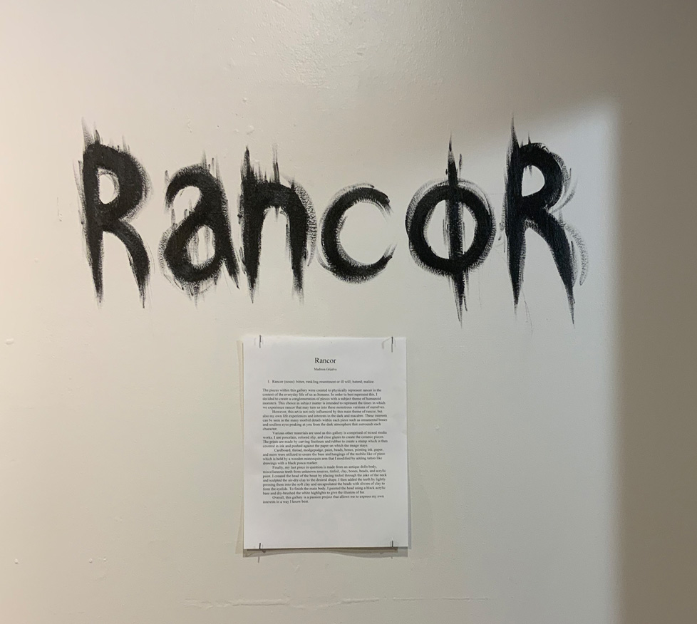 title painted on wall with horror font and statement below