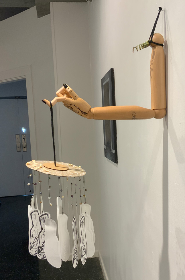 wall sculpture, arm with one finger used as hook to hang a mobile