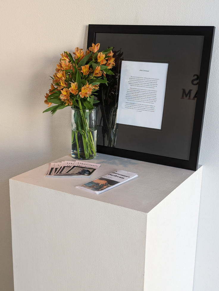 framed statement, flowers, and handouts on pedestal