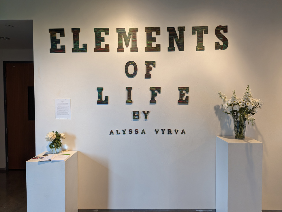 show title on wall, statement, and flowers