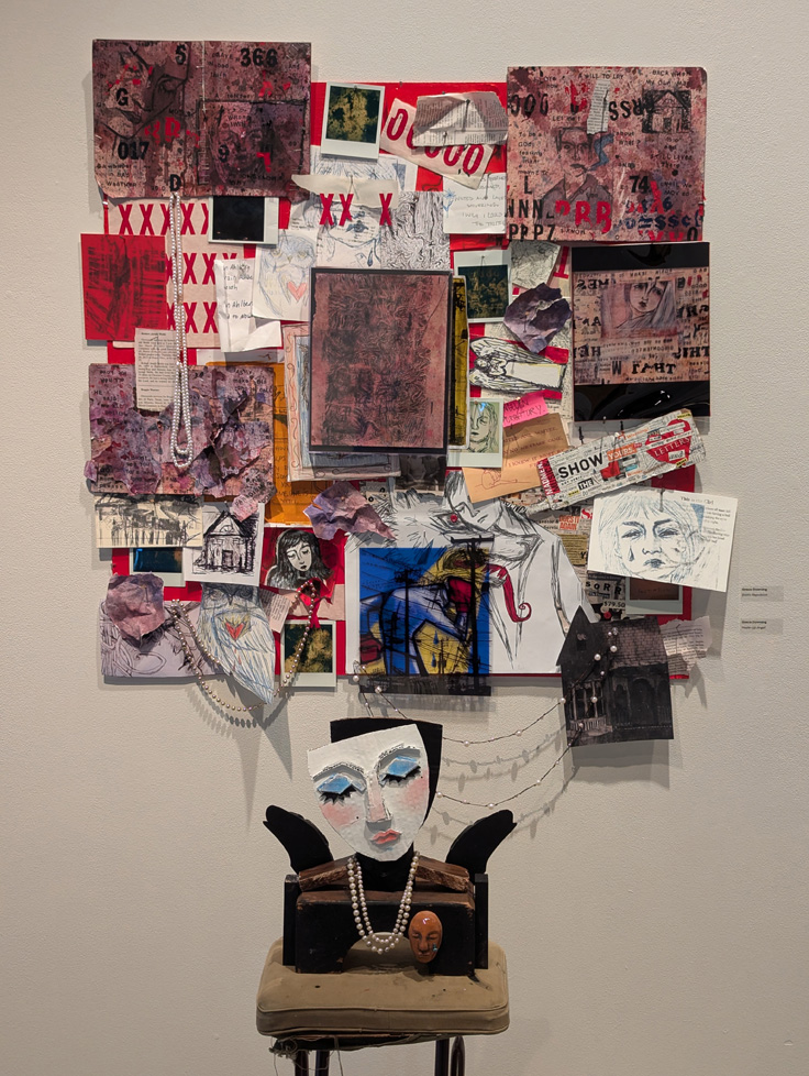 collaged installation on wall above assemblage sculpture of angel