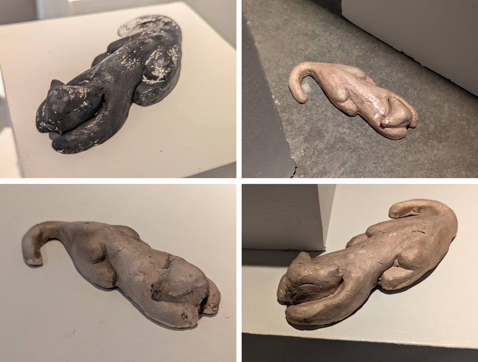 four photos of plaster cat scupltures, one on floor