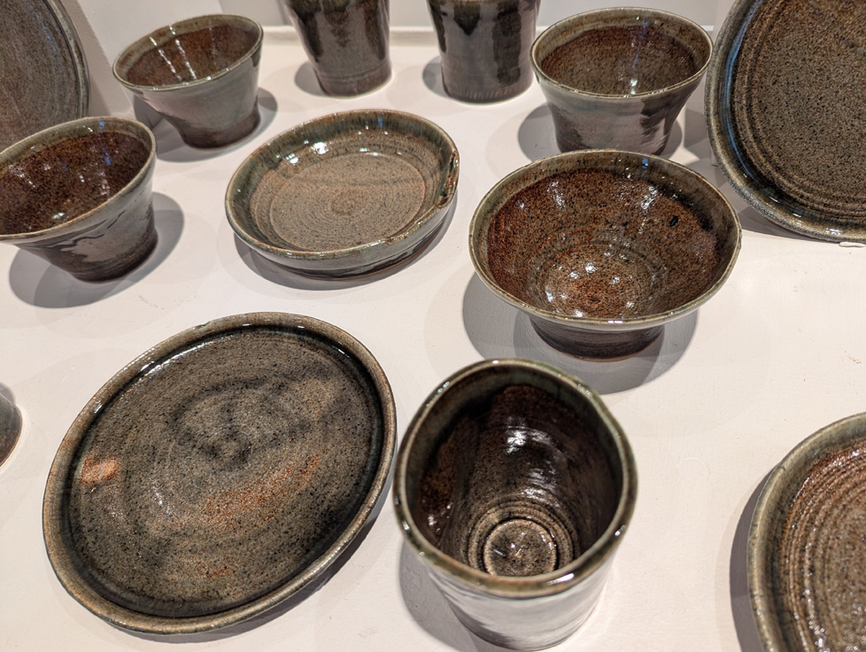 closer view of some of the cups, bowls, and plates