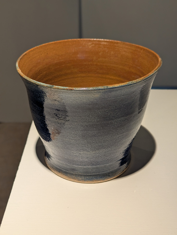 large bowl with blue exterior and brown interior