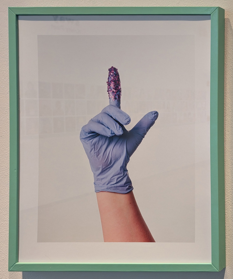 rubber gloved had with glitter on pointer finger
