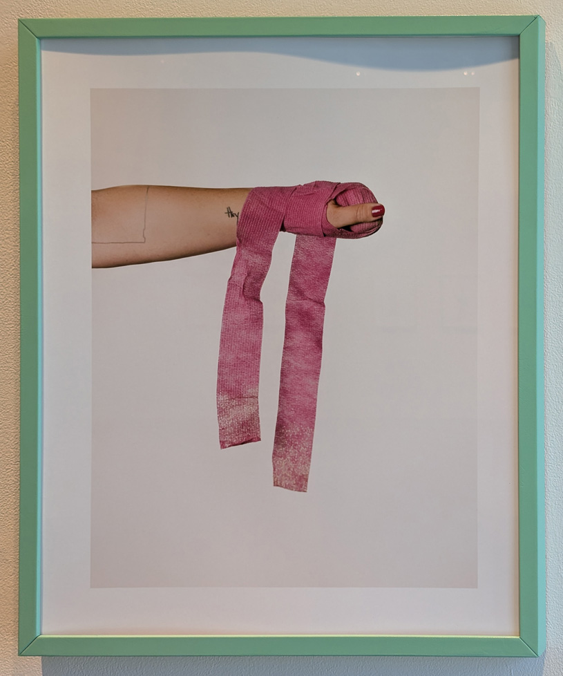 hand wrapped in pink bandage