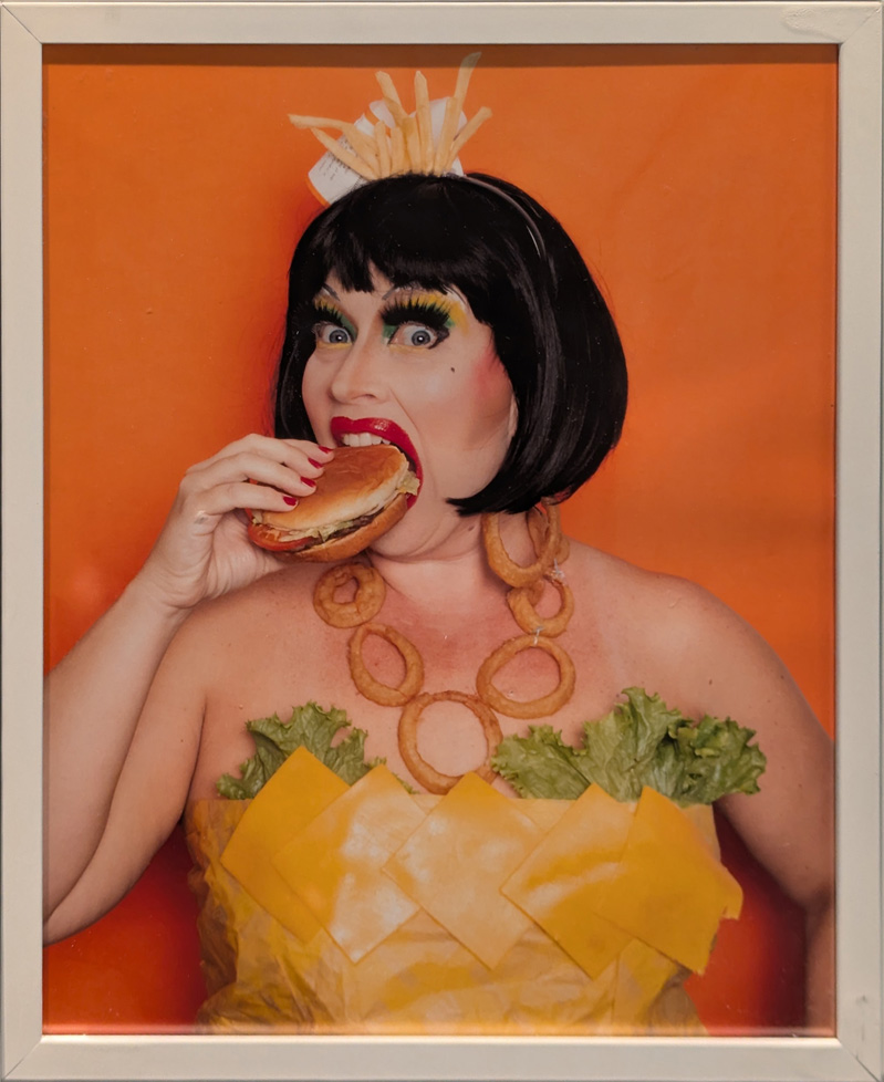 woman eating hamburger dressed in burger ingredients