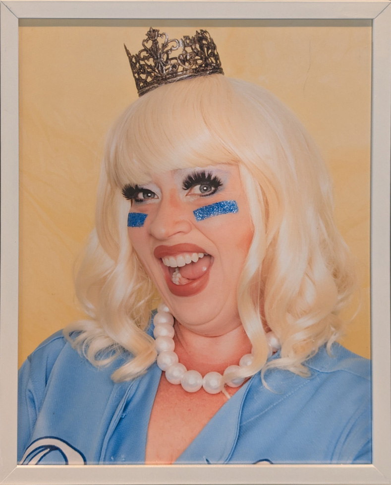 woman in blue wearing small crown