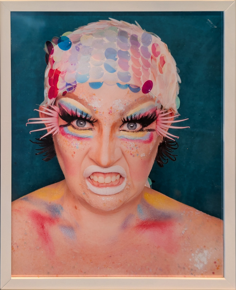 woman with fierce expression and colorful makeup