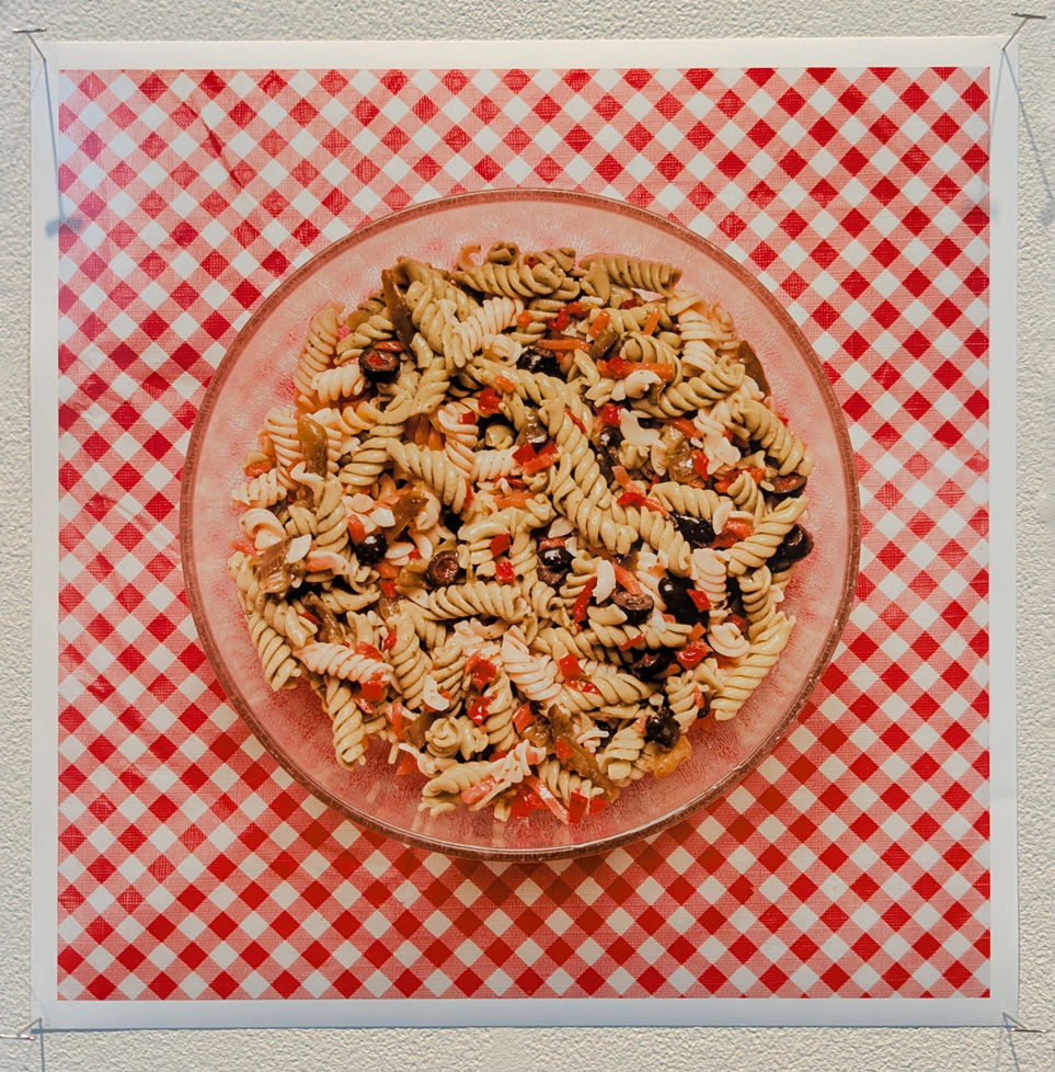 pasta salad in bowl on checkered tablecloth