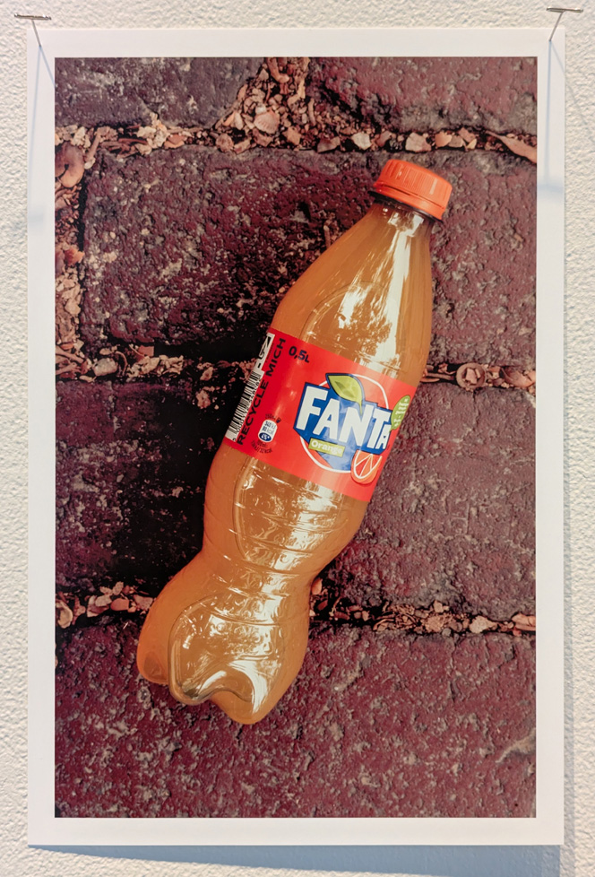 bottle of orange fanta on pavement