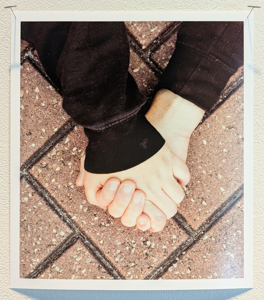 clasped hands over bricks