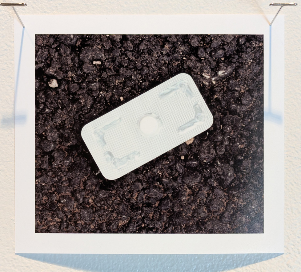 pill in wrapper on tarmac