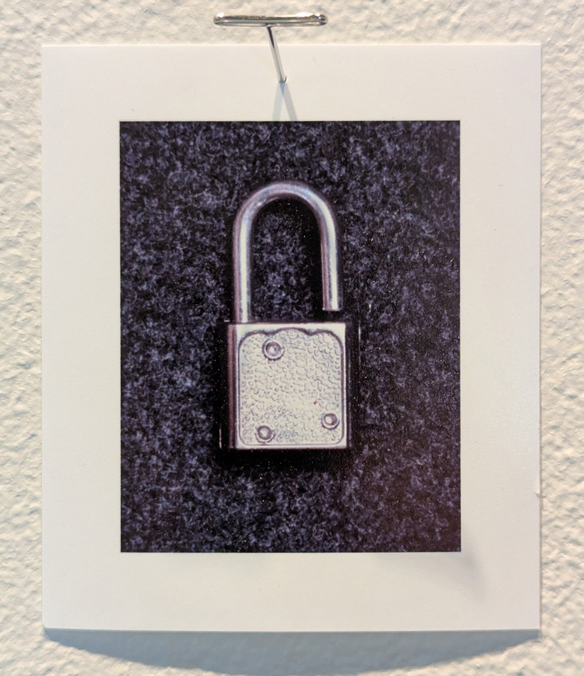 small open padlock, like you might find on a diary