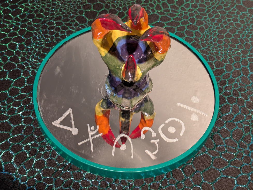 detail of colorful claw on mirror with text