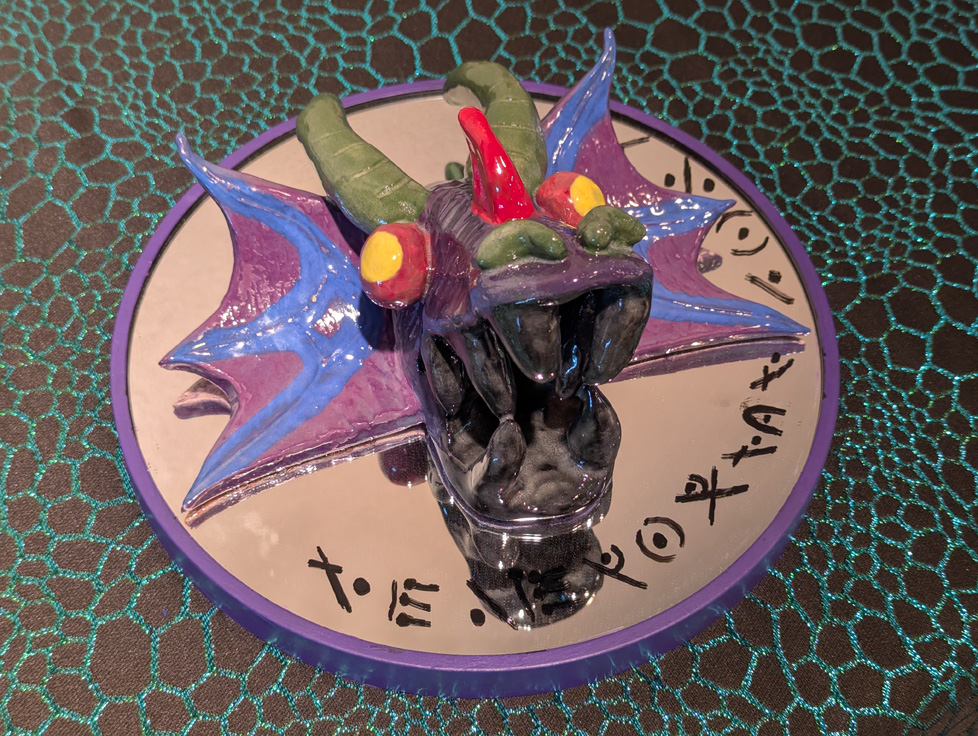 detail of colorful dragon head with cryptic text