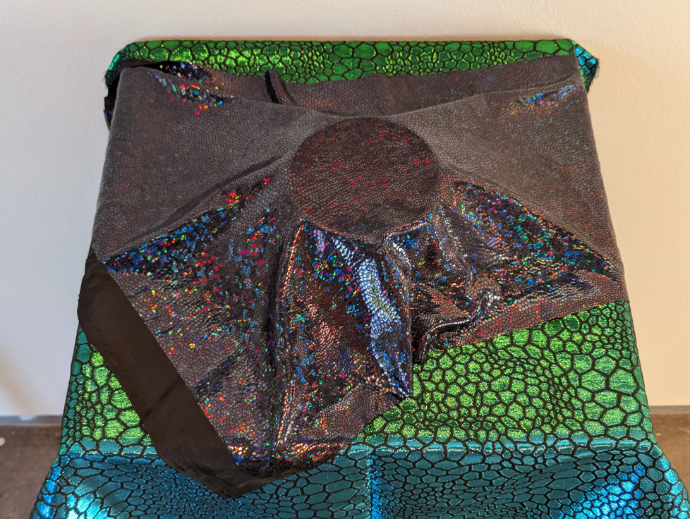 bowl on pedestal covered with shimmering fabric