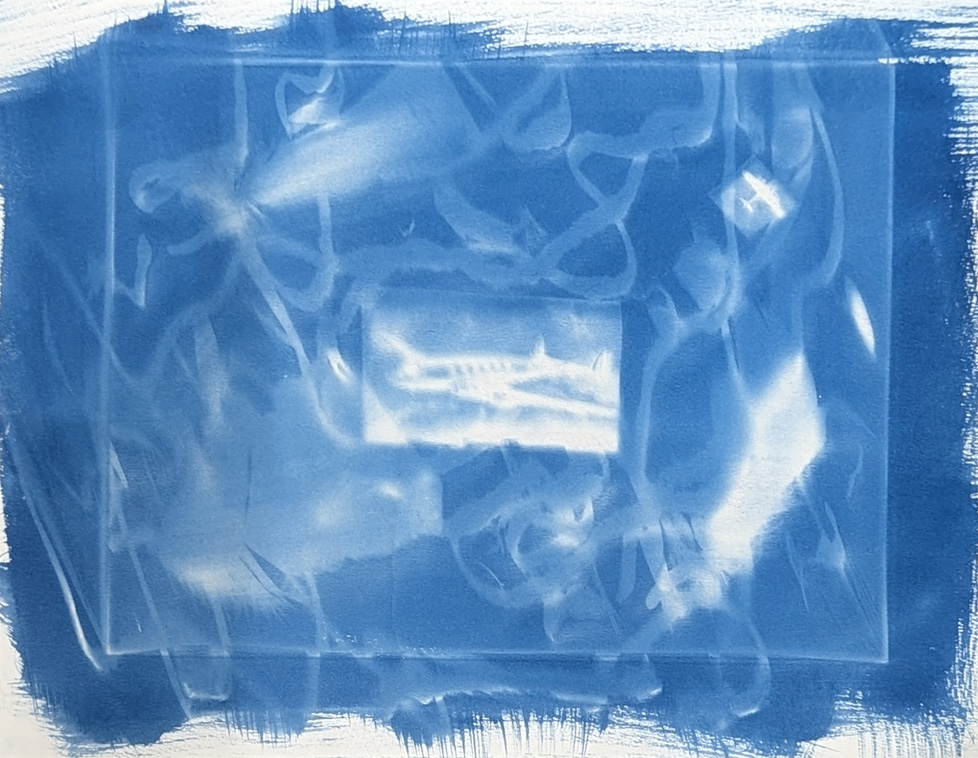 cyanotype with airplane and swirling lines in a box